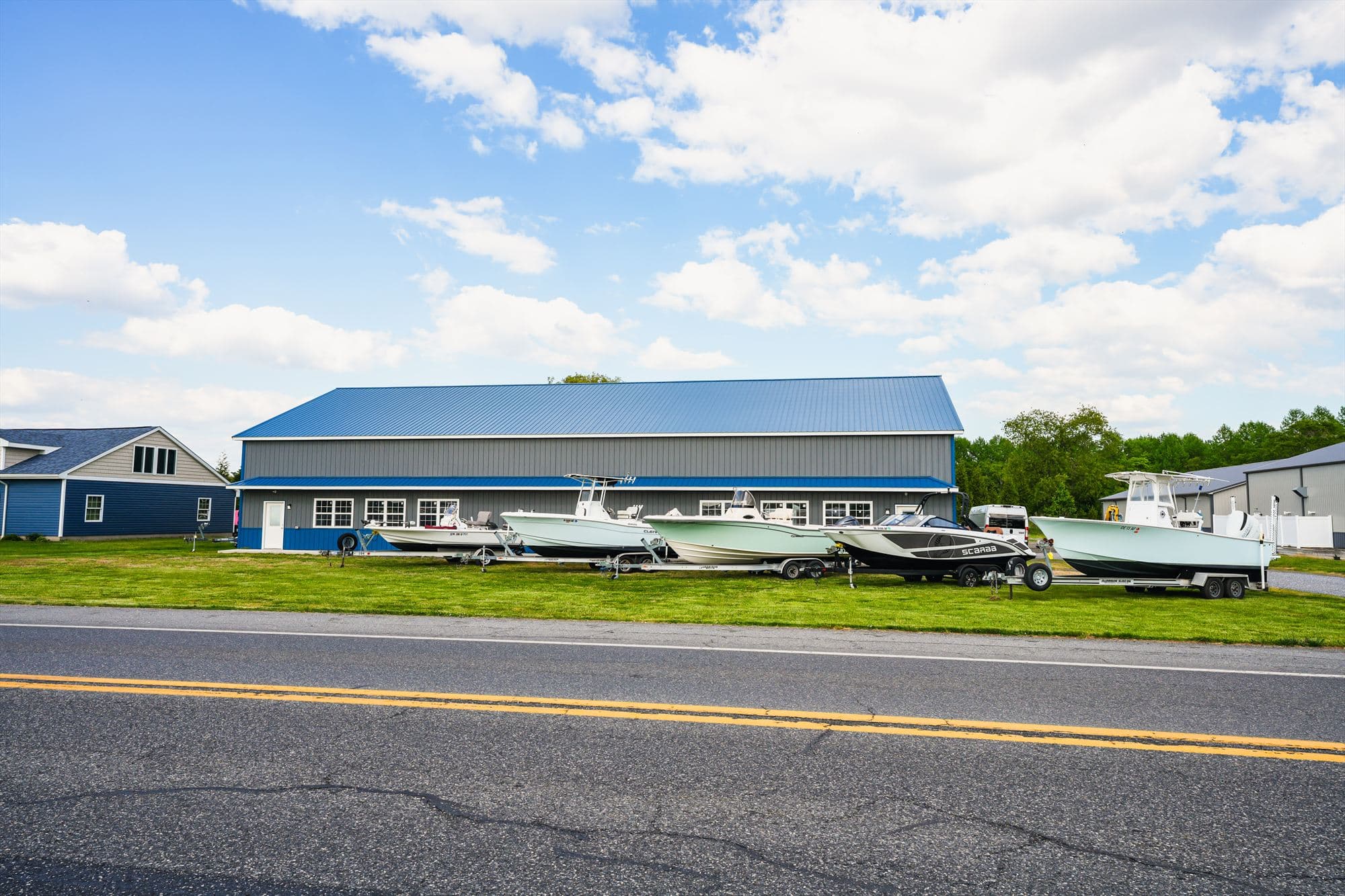 Delmarva Service Center seen from Harbeson Road, with boats lined up along the building