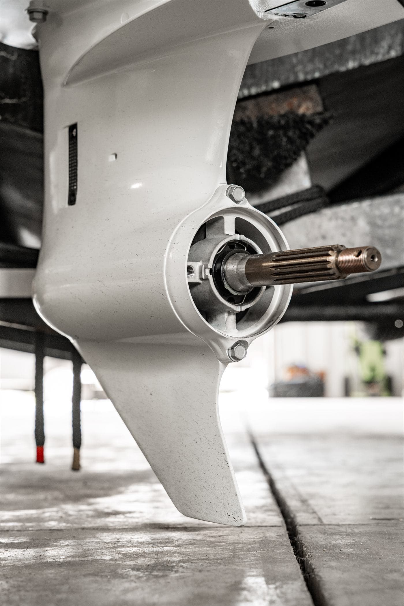 Close-up of an outboard lower unit with the propeller shaft exposed for service