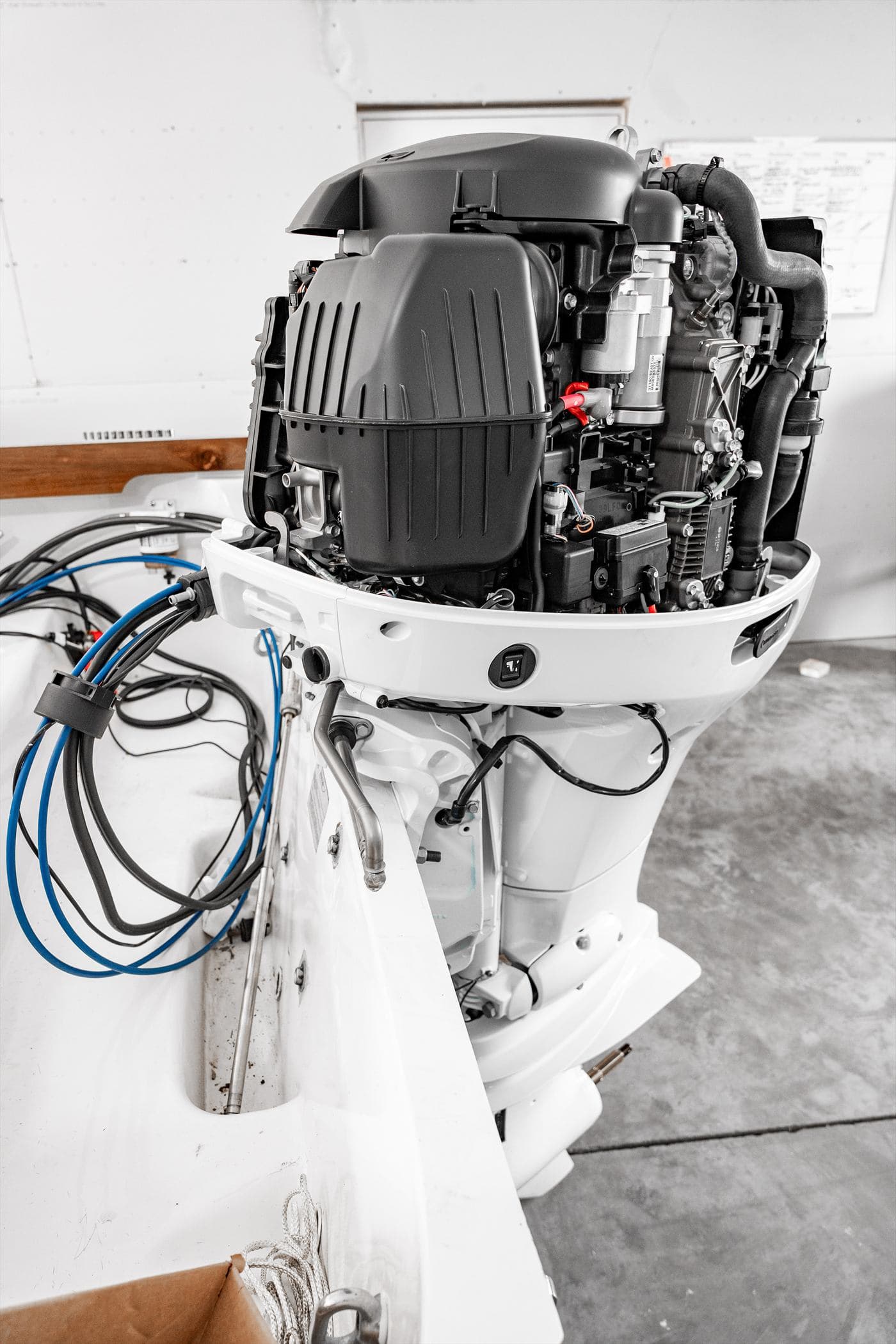 Outboard engine with the cowling removed, exposing the powerhead during service